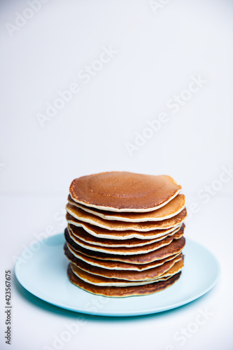 Stack of Tasty pancakes on white background
