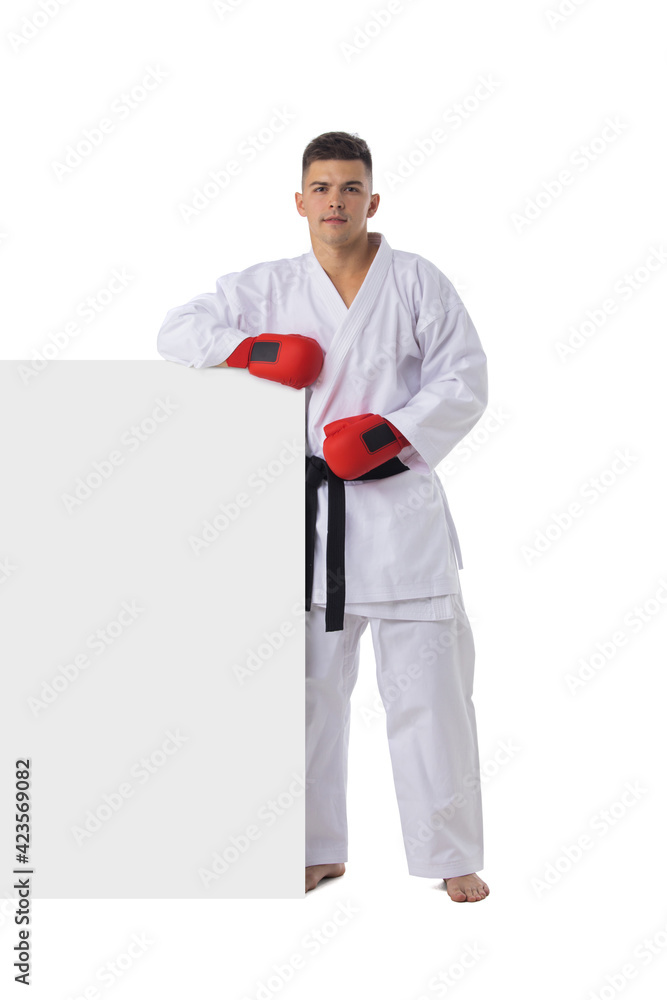 Man training taekwondo on white