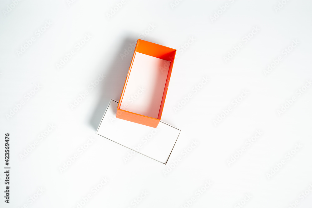 Open cardboard box with orange-red box cover on a white background Open cardboard box with orange-red box cover on a white background