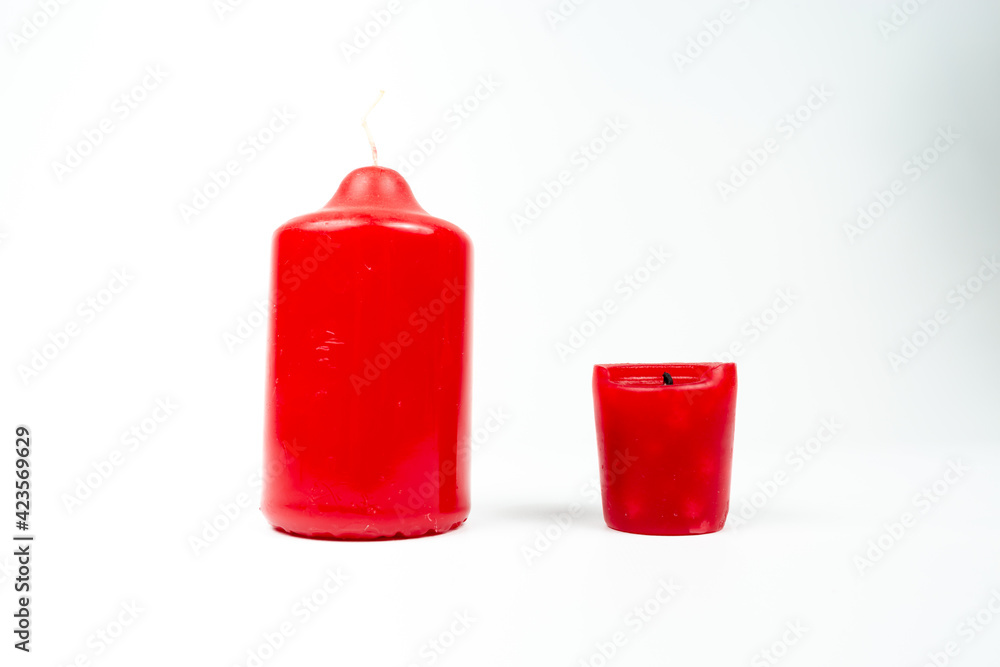 large new and burnt red candle on white background, burnout concept large new and burnt red candle on white background, burnout concept