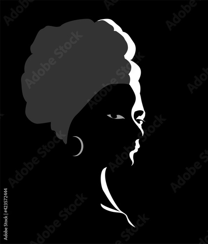 Beautiful african woman with a turban. Head portrait. Vector illustration silhouette on a black background.