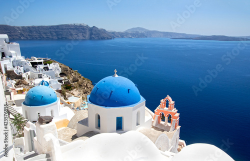 Oia town in Santorini  Greece.  Blue domed churches Agios Spyridonas and Anastaseos.