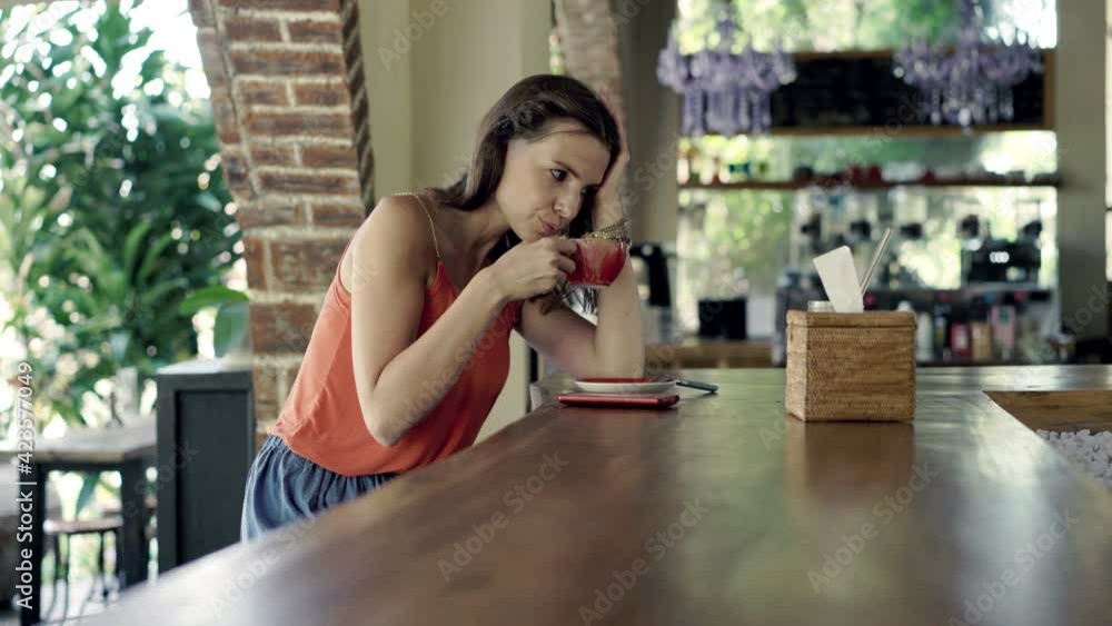 Sad woman drinking coffee and waiting for someone in cafe, 4K
Sad woman drinking coffee and waiting for someone in cafe, 4K