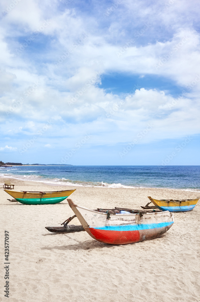 Small fishing boats on an empty beach, Sri Lanka.