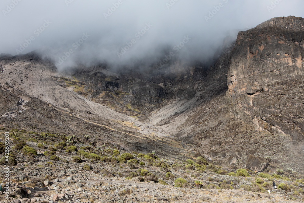 The fog descends down into the valley in Mount Kilimanjaro.
