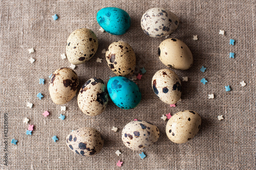 easter eggs on a craft background with decorative sprinkles, top view