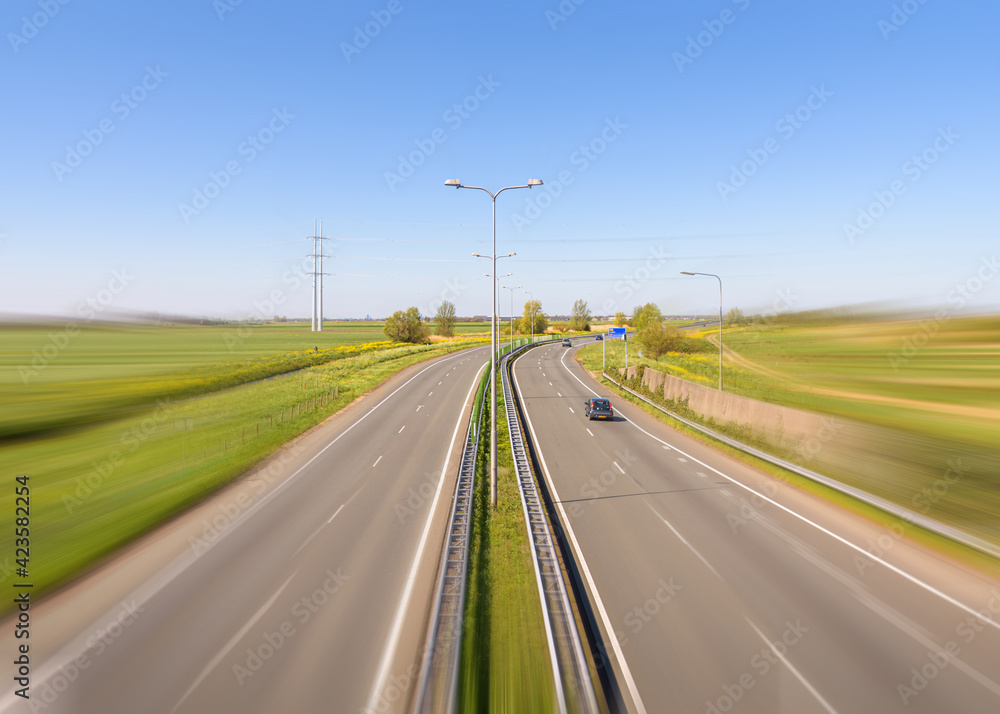 Rural road with two times two lanes with motion blur in the Netherlands. Rural road with two times two lanes with motion blur in the Netherlands.