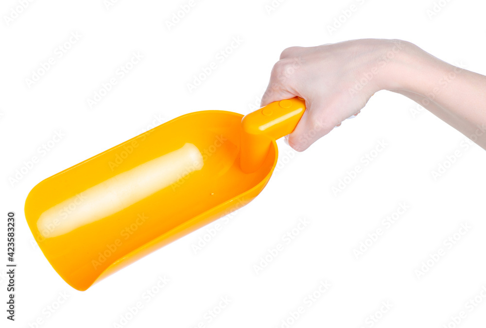 Plastic scoop for groats in hand on white background isolation