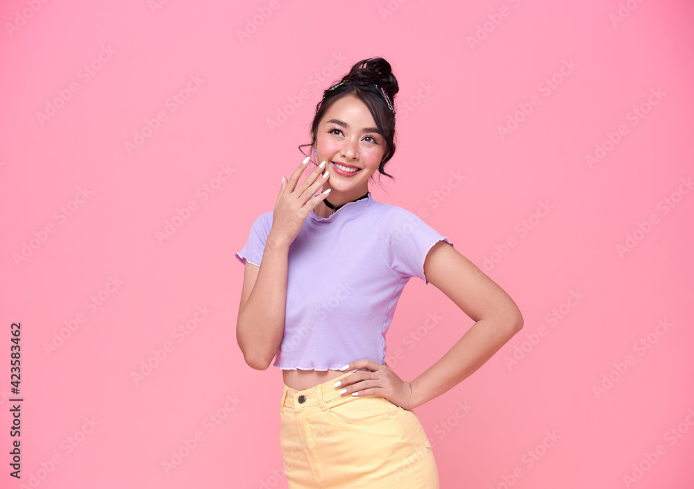 Happy young Asian teenage girl on pink background. Happy young Asian teenage girl on pink background.