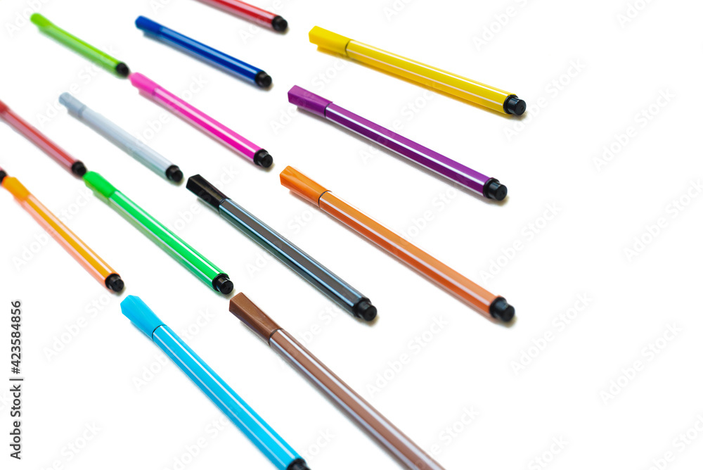 A pile of colorful felt tip pens isolated on the white background. A pile of colorful felt tip pens isolated on the white background.
