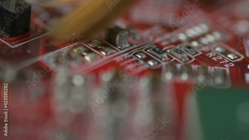 Cleaning the red microcircuit with a dry soft brush