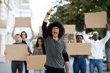 Guy leading international group of students strikers with blank placards
