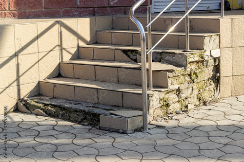 Old concrete stairs crumble from old age and poor repairs photo