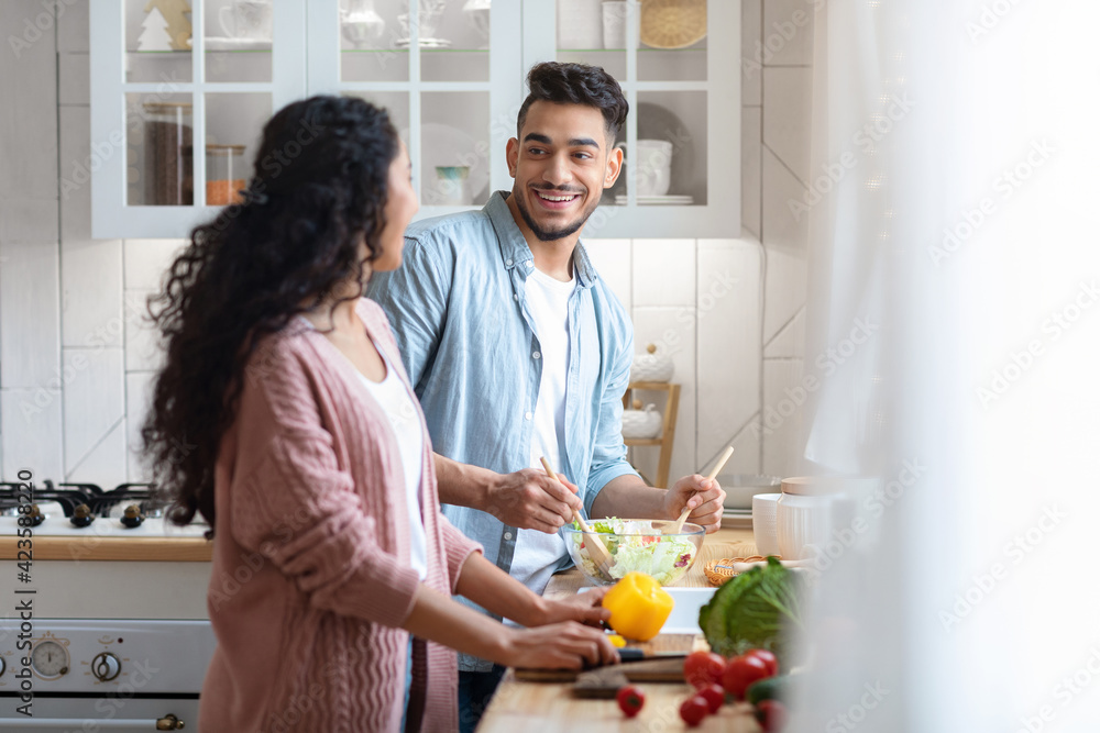 Happy Arab Spouses Preparing Healthy Lunch Together In Kitchen Happy Arab Spouses Preparing Healthy Lunch Together In Kitchen
