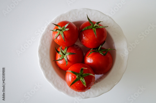Top view of tomatoes in a white plate    © Okan