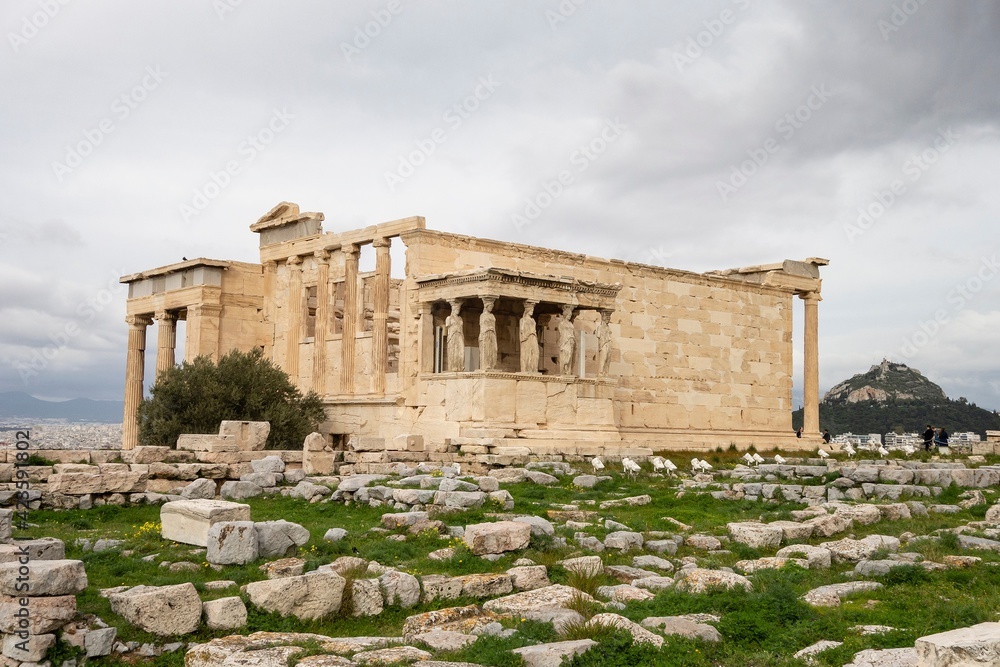 Ruin of the Erechtheion temple at Acropolis, Athens, Greece with tourists around