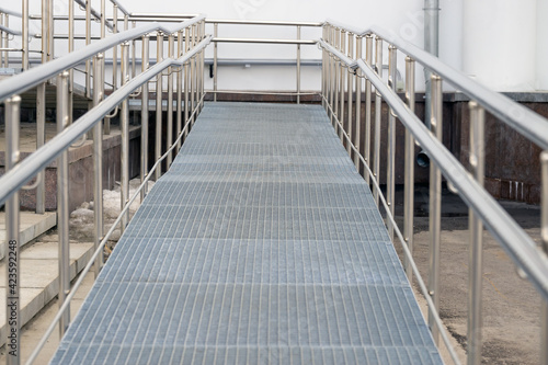Metal ramp with railing for sedentary people