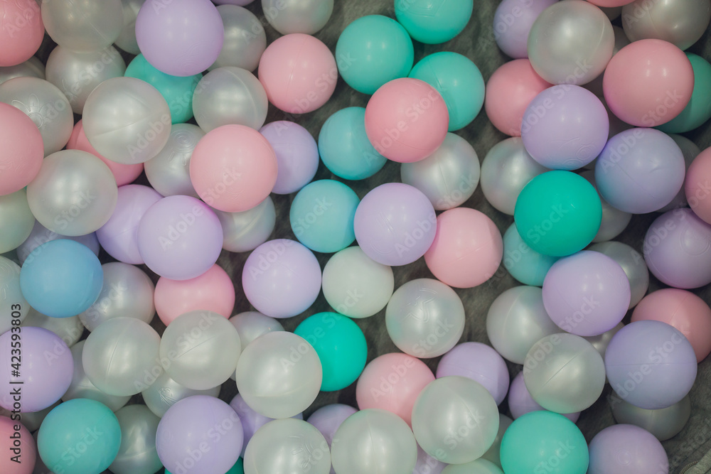 Background, colorful plastic balls on children's playground.