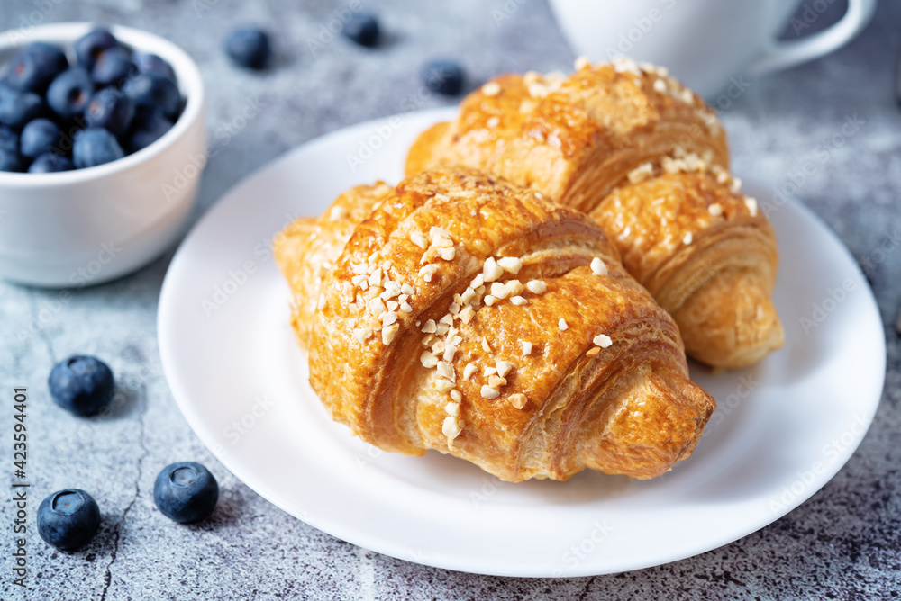 Fresh croissants with berries and cup of coffee Fresh croissants with berries and cup of coffee