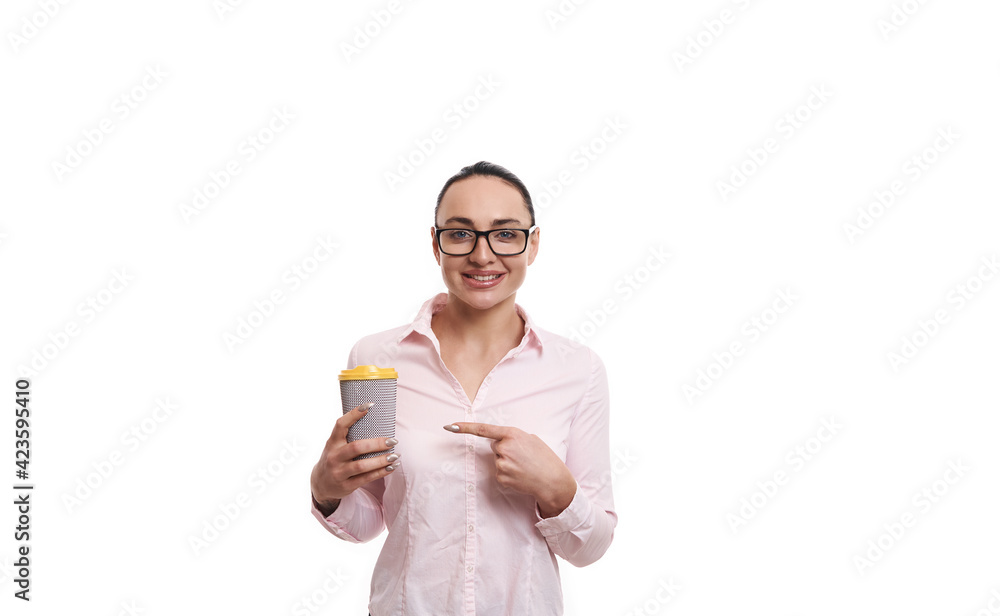 Smiling cheerful woman pointing with index finger at recyclable takeaway paper cup with hot drink isolated on white background. Copy space Smiling cheerful woman pointing with index finger at recyclable takeaway paper cup with hot drink isolated on white background. Copy space