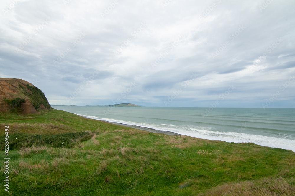 Green Cliffs at Te Waewae Bay with view of Pahia point at distance, The Catlins, Southland, New Zealand