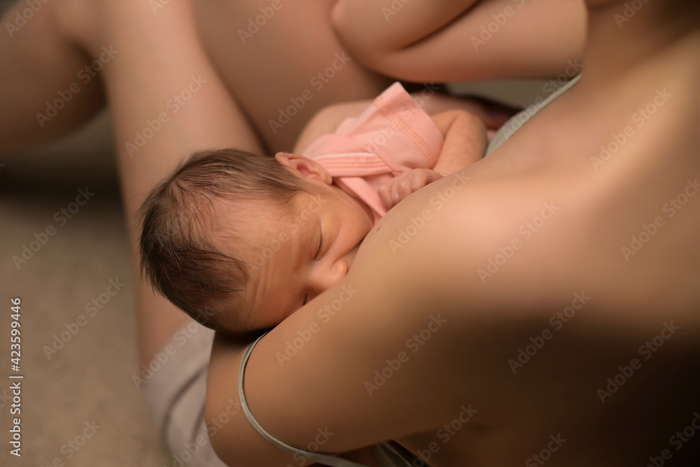 Close-up of newborn baby being milked by a young mother Close-up of newborn baby being milked by a young mother
