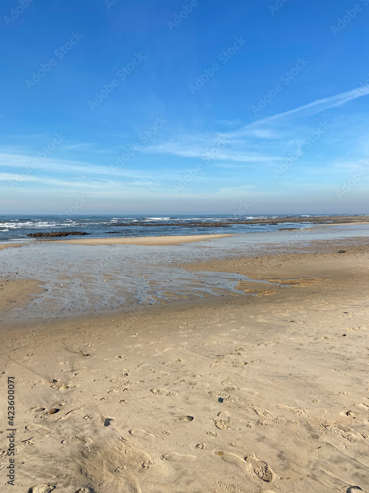 Sea, beach boulders, pebble shore and waves. Sea waves breaking on rocks. Sunny beach with sand dunes and blue sky in Cepaes, Esposende, Portugal. Sea, beach boulders, pebble shore and waves. Sea waves breaking on rocks. Sunny beach with sand dunes and blue sky in Cepaes, Esposende, Portugal.