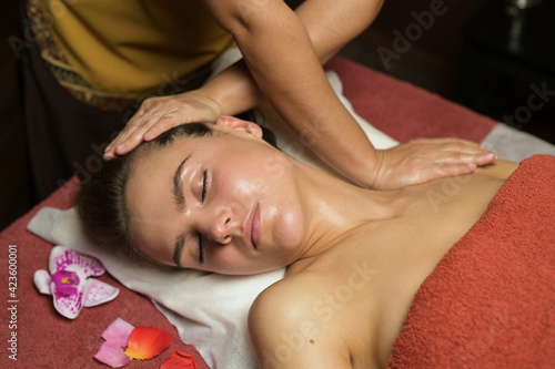 Young good looking woman relaxes on thai massage