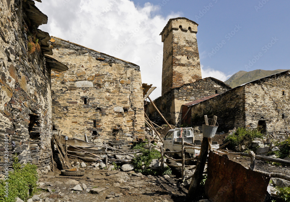 A medieval defensive tower rises above the more recent stone homes of Ushguli village, Upper Svaneti, Georgia