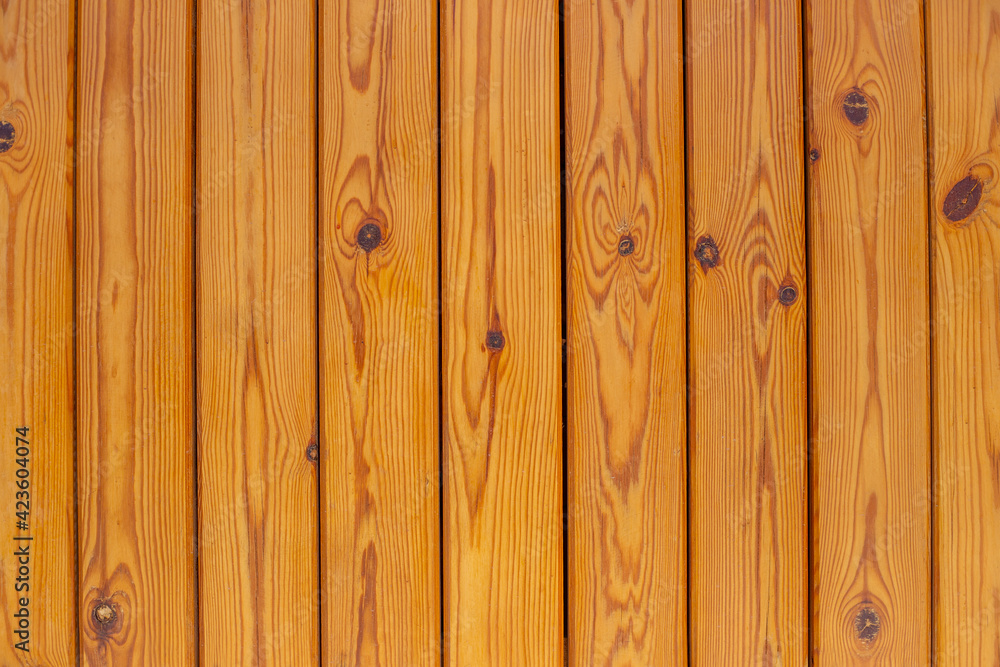 Fototapeta premium Wooden brown bars. Texture of the light wood boards lie vertically. Wood background