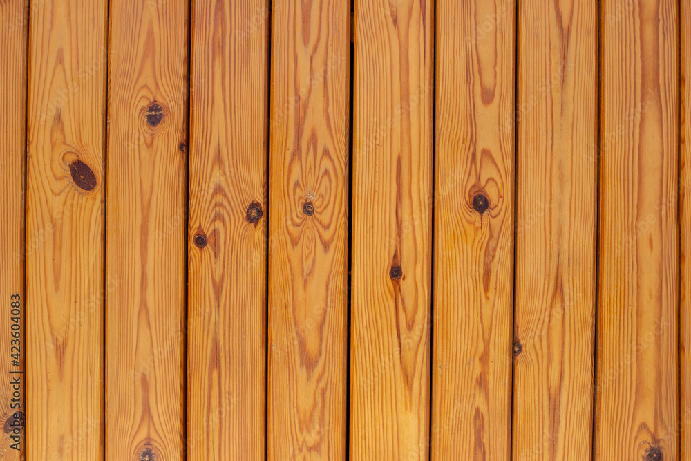 Naklejka premium Wooden brown bars. Texture of the light wood boards lie vertically. Wood background