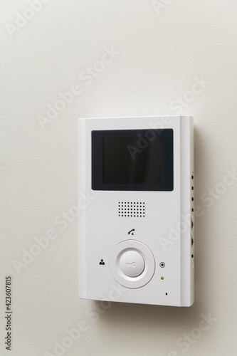 white video intercom on the wall in the apartment, free space