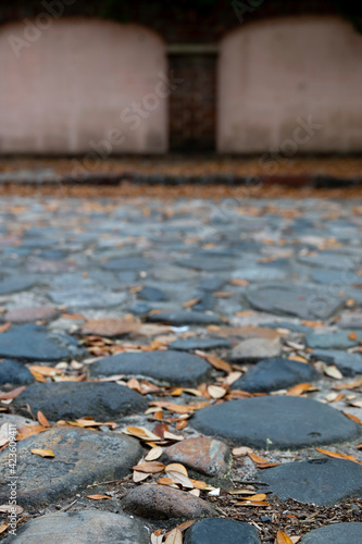 Cobblestone street from 18th century, with wall in background and increasing bokeh.