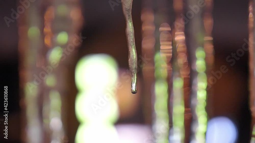 Icicles Melting at Night Close-Up Bokeh Shot photo