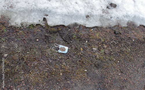 mask and cigarette ends on the ground