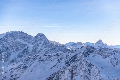 Panorama of the Caucasus mountains from Elbrus. Peaks of the sharp mountains from the highest mountain in the area. Mountains around Elbrus from a height of 4500 meters.