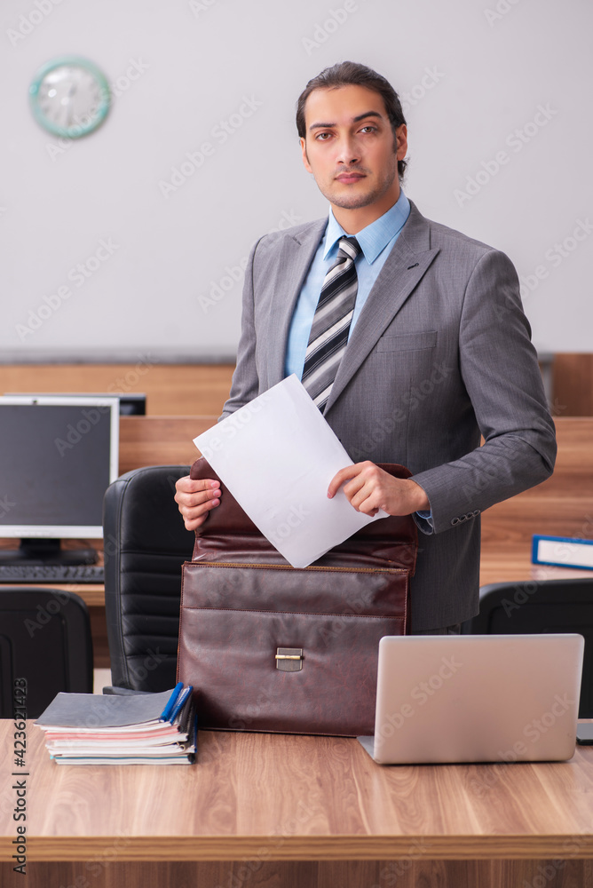 Young male employee working in the office Young male employee working in the office