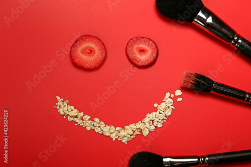 Cosmetic concept. Homemade facial mask of strawberry and oatmeal. Makeup brushes
