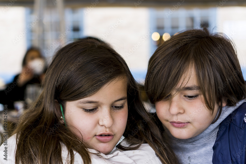 portrait of children looking at their tablet