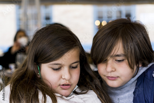 portrait of children looking at their tablet photo