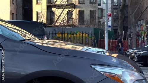 Houston Street art murals colorful graffiti along st cars driving Downtown Manhattan New York City NYC