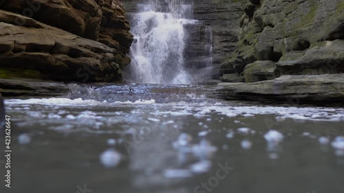 Low angle view of rocky valley waterfall and mountain river photo