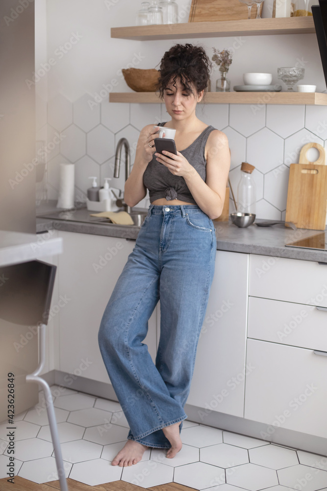 Joyful brunette woman chatting surfing internet use smartphone enjoying coffee break at cafe Joyful brunette woman chatting surfing internet use smartphone enjoying coffee break at cafe