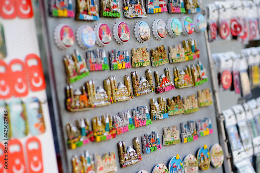 Sale of magnets, postcards, bottle openers, bookmarks, calendars, key rings and other souvenirs on the street of Istanbul. Gift and keepsakes from travels by Turkey.