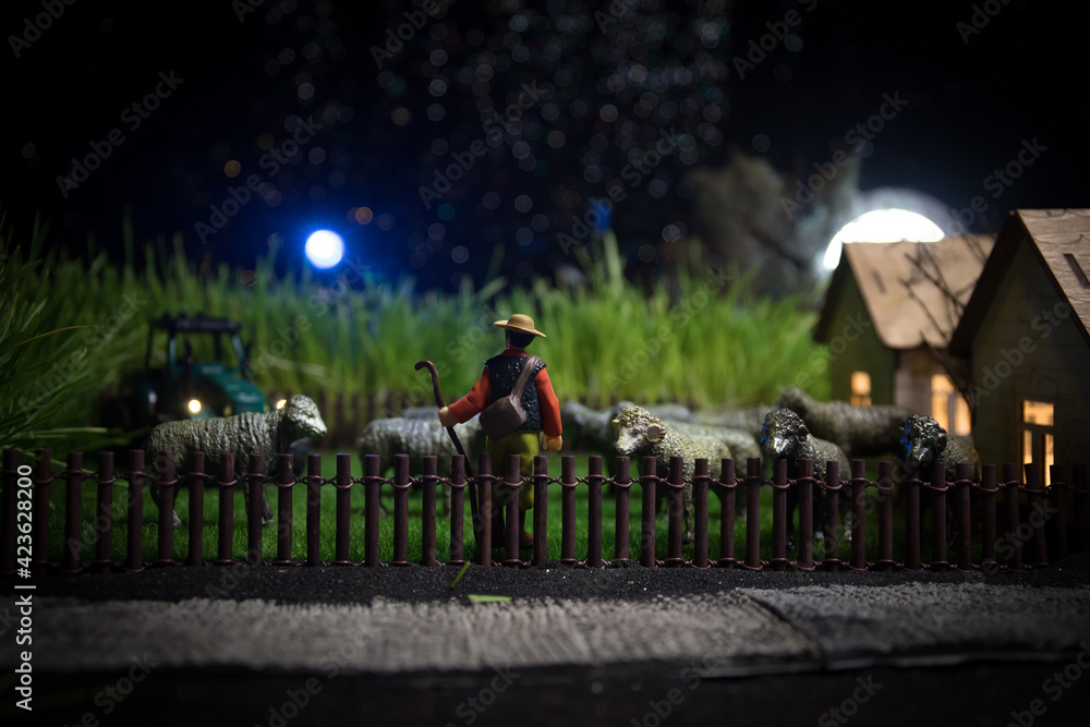 Sheep in the farm. Farm (village) life concept. Decorative toy figures at night. Selective focus Sheep in the farm. Farm (village) life concept. Decorative toy figures at night. Selective focus