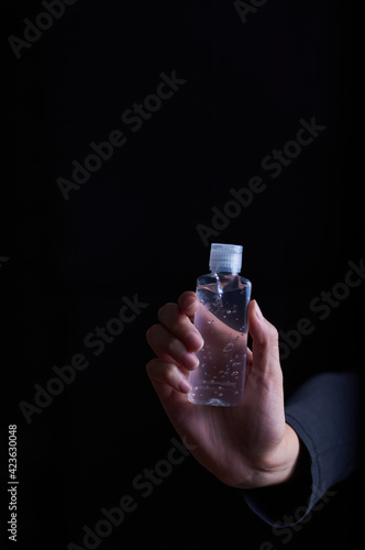 woman's hand holding alcohol gel