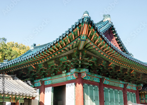 A fragment of the wooden, carved and colorful roof of the Changdeokgung Palace in Seoul, South Korea