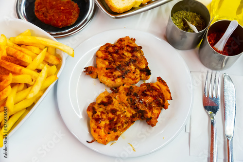 Turkish cuisine. Savory chicken chops prepared on mangal served with side dish of fried potatoes