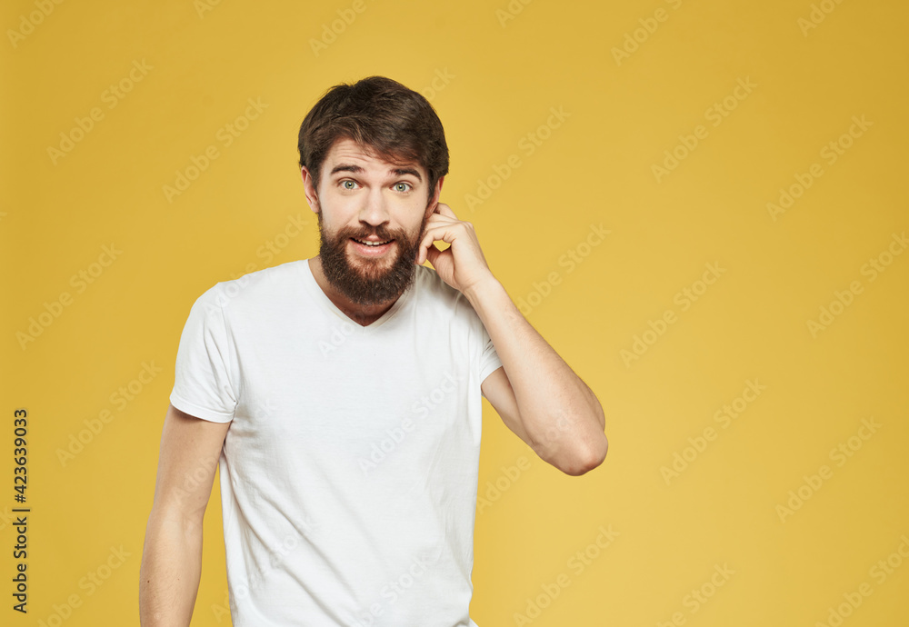 male model gesturing with his hands on a yellow background cropped view male model gesturing with his hands on a yellow background cropped view