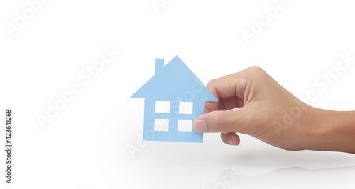 Hands holding paper house  family home  protecting insurance concept